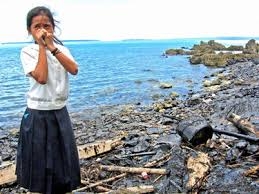 Girl cries in oil spill debris